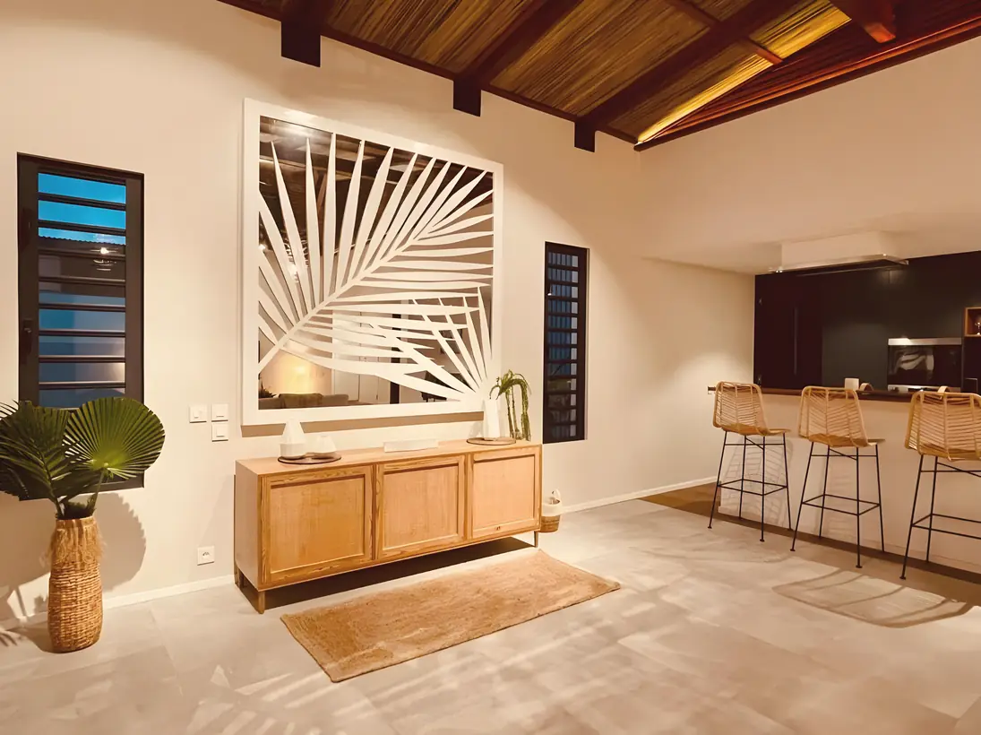 Kitchen and bar under a timber ceiling with a carved palm-leaf screen