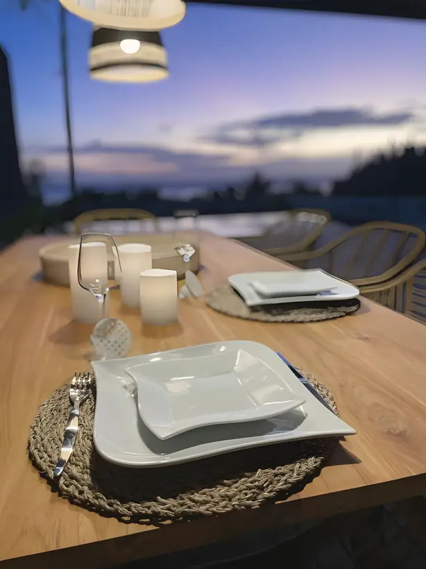 A table laid on the terrace at dusk